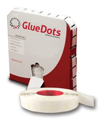 A roll of white glue dots next to a box.