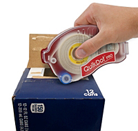 A person is holding a tape dispenser over the box.